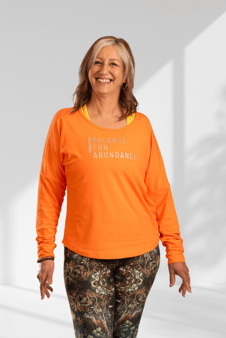 Creating | Orange long sleeve activewear top for women - Empowered Clothing - stride